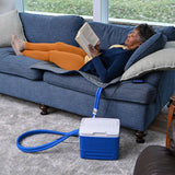 Woman laying on the couch using the Polar Active Ice® 3.0 38" x 22" Blanket Cold Therapy System under her body