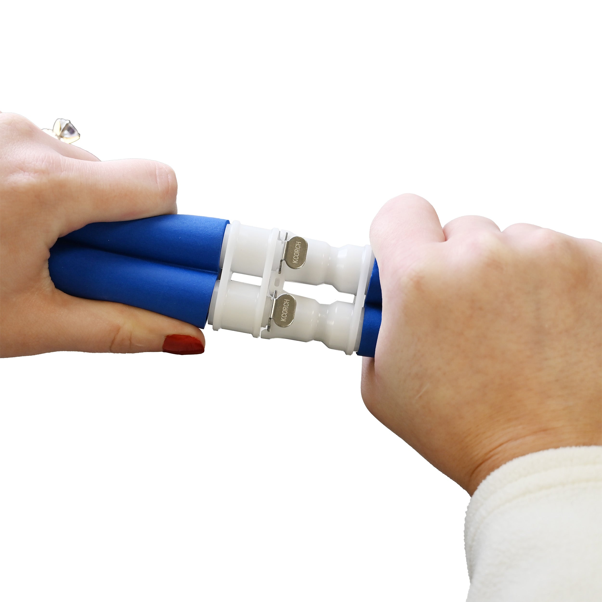 Pair of hands connecting Active Ice® insulated tubing with male and female dual metal tab couplings on a white background
