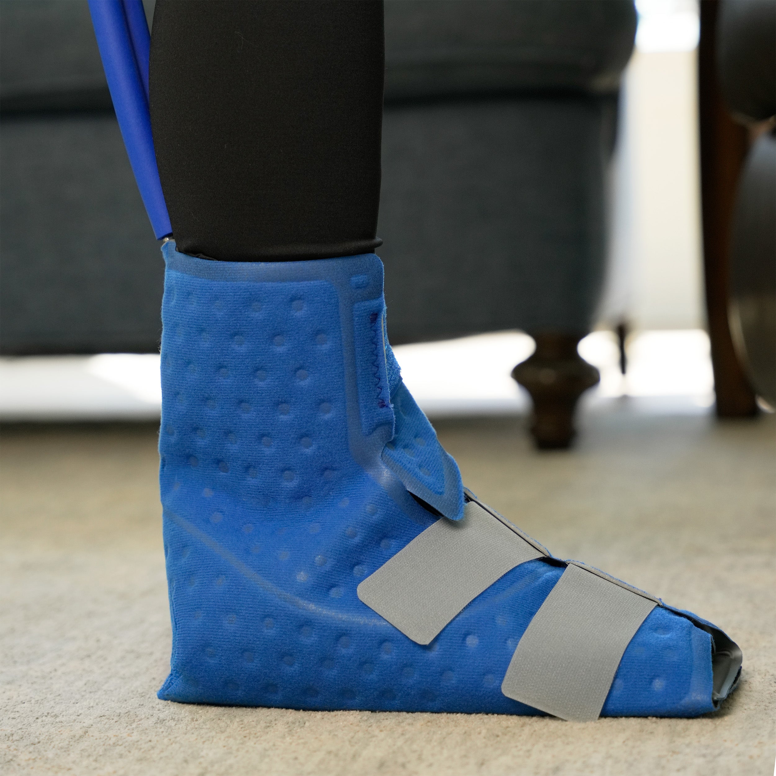 Upper Foot & Ankle Cold Therapy Pad on a woman's foot in a living room setting