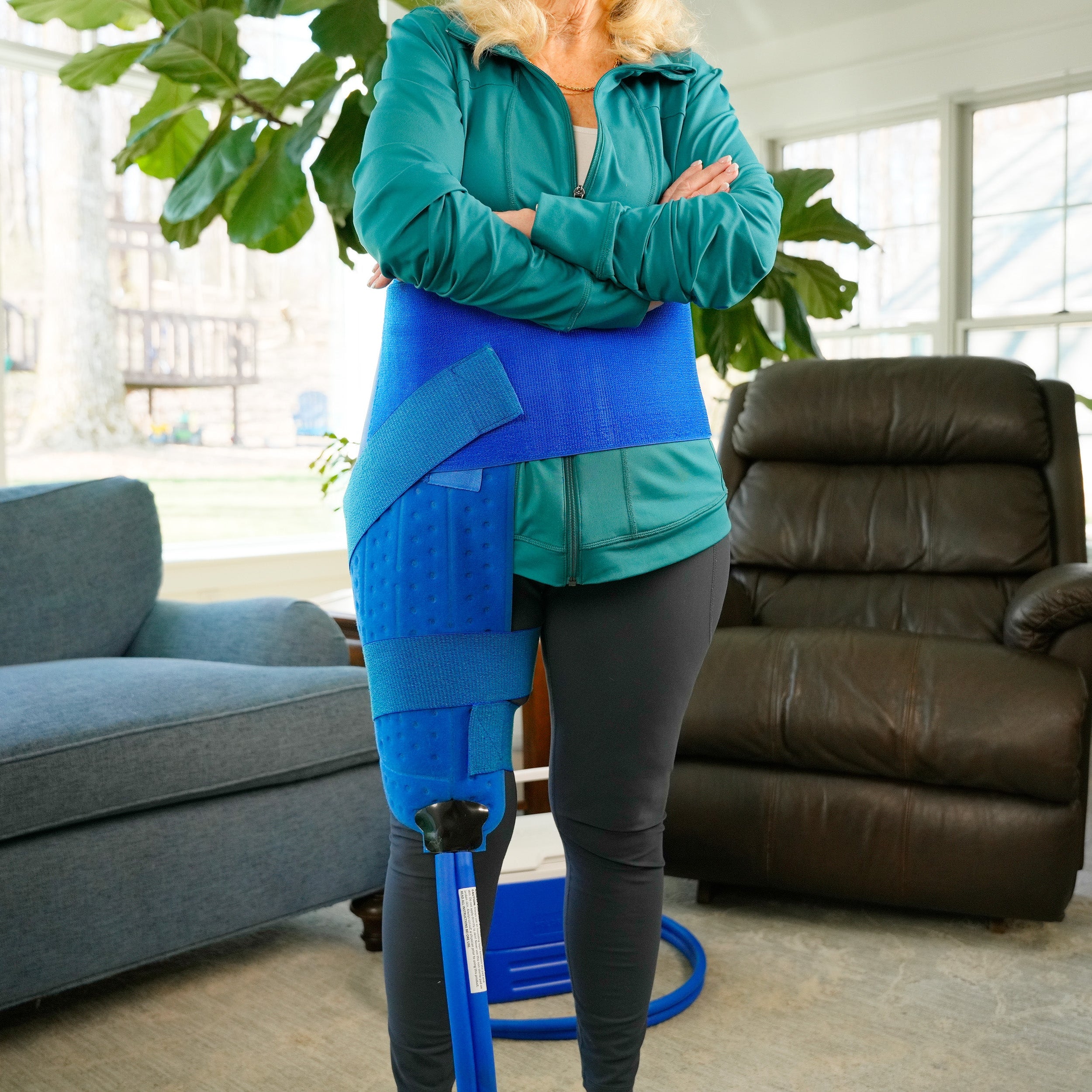 Woman wearing an Extended Coverage Hip Cold Therapy Pad, in a living room setting.