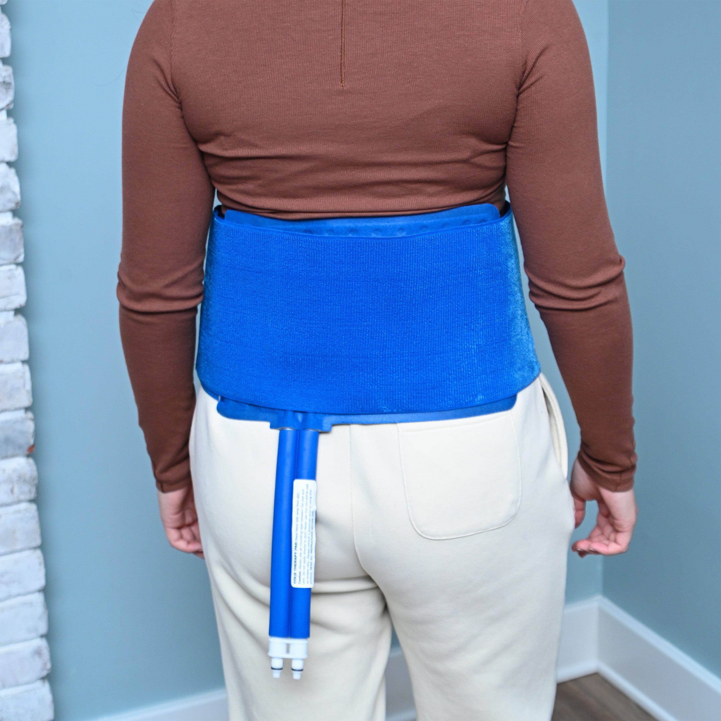 Person wearing blue Active Ice® 3.0 Back & Hip Cold Therapy Pad on back