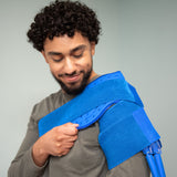 Man wearing a Broad shoulder therapy pad on a light background