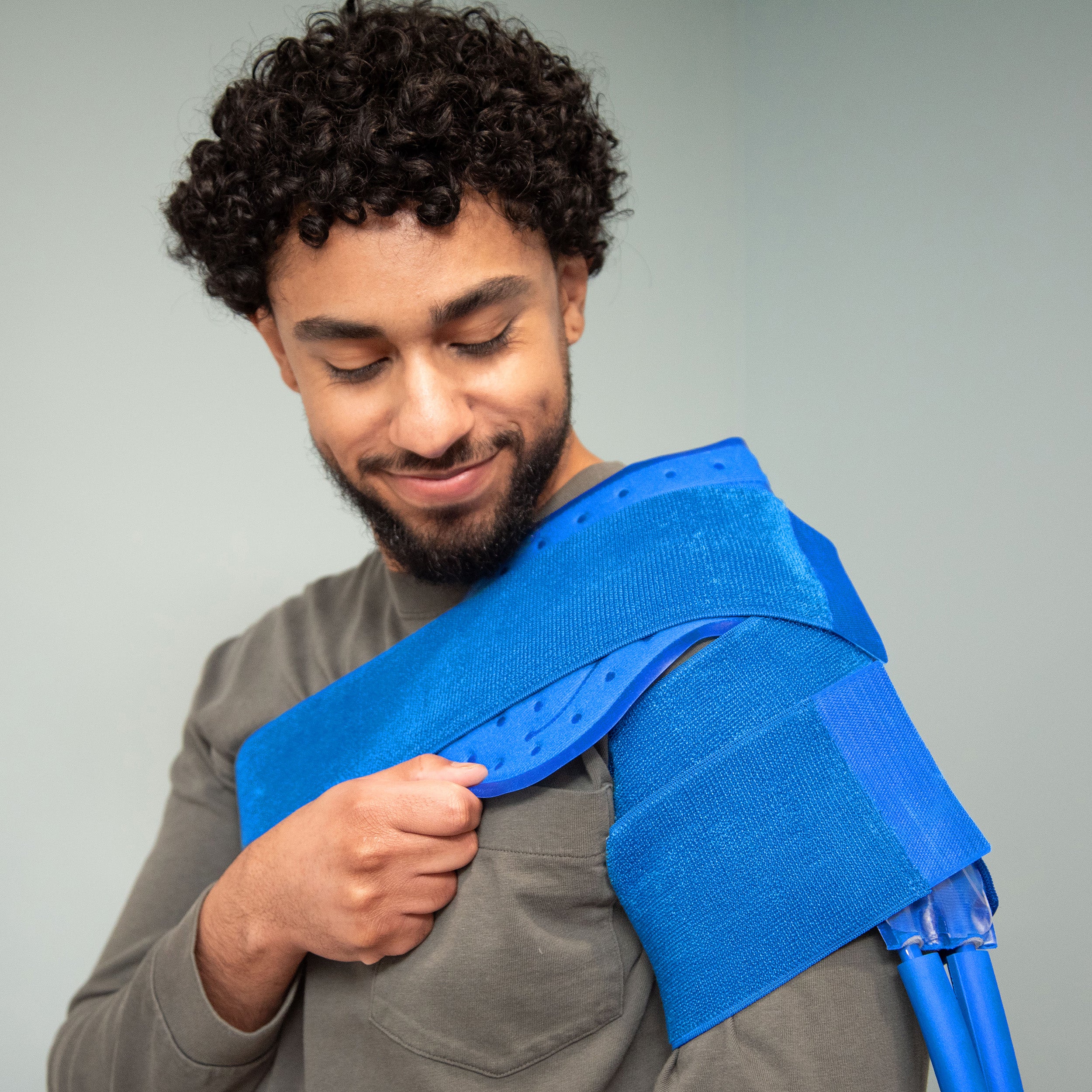 Man wearing a Broad shoulder therapy pad on a light background