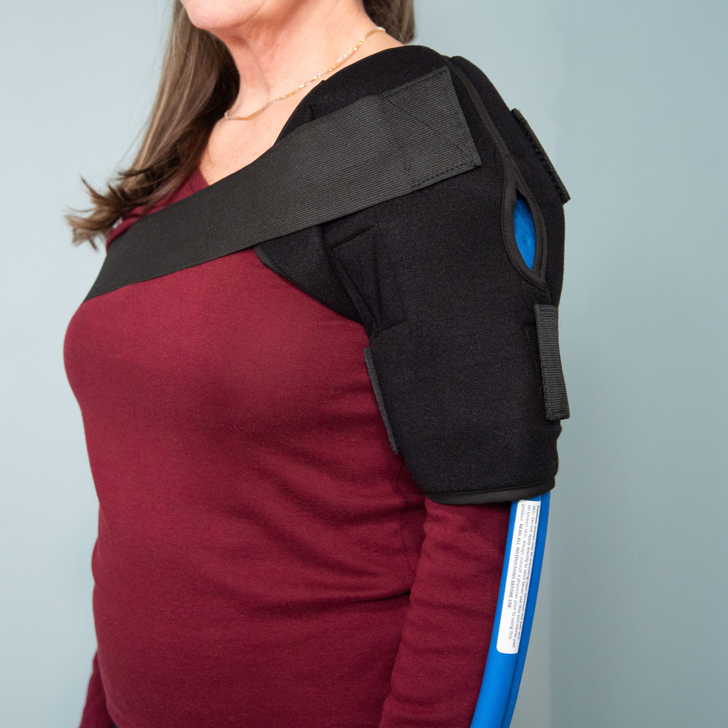Person wearing a Polar Active Ice® 3.0 Universal Therapy Pad with Shoulder Compression Wrap on a gray background