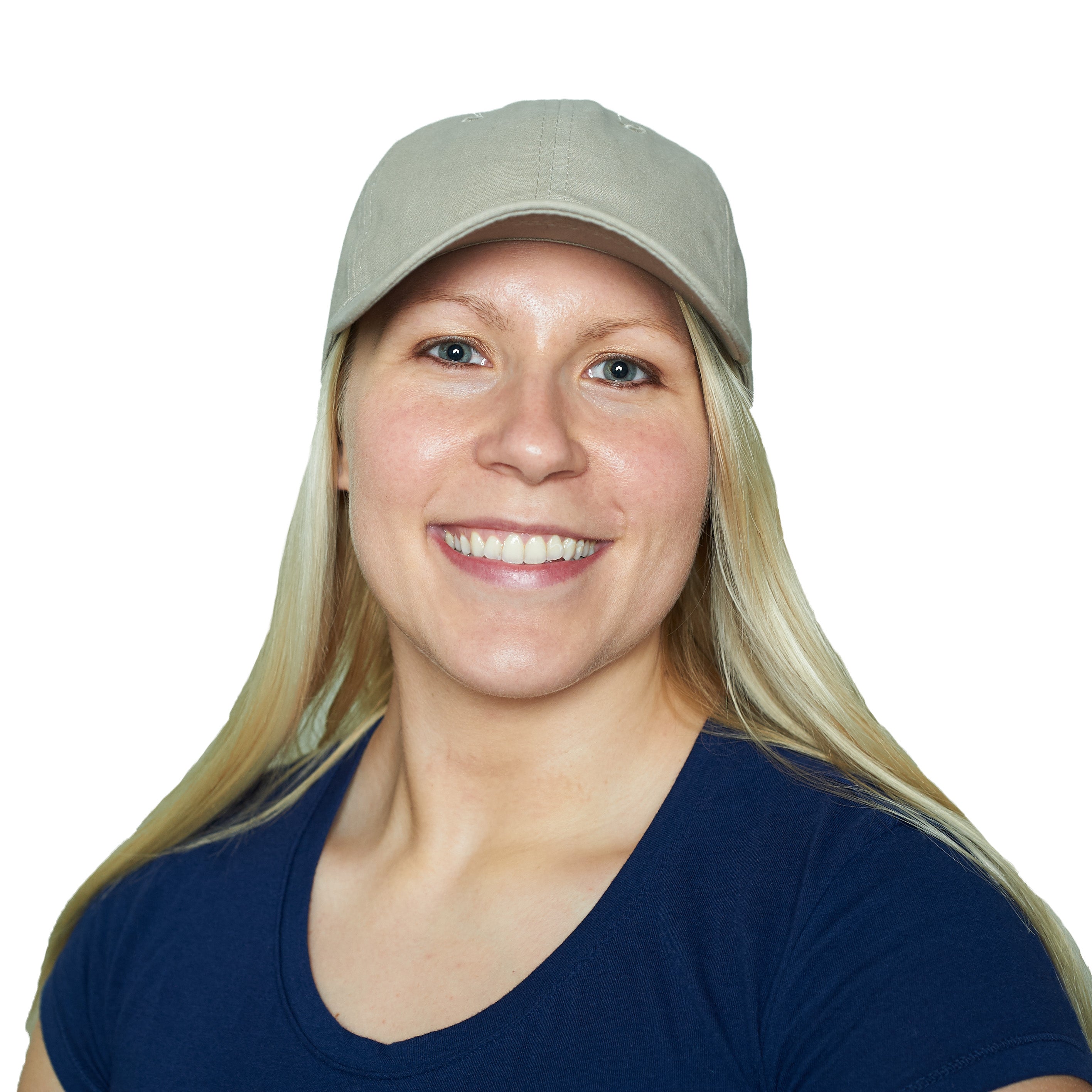Woman wearing a beige cooling cap and navy shirt on a white background