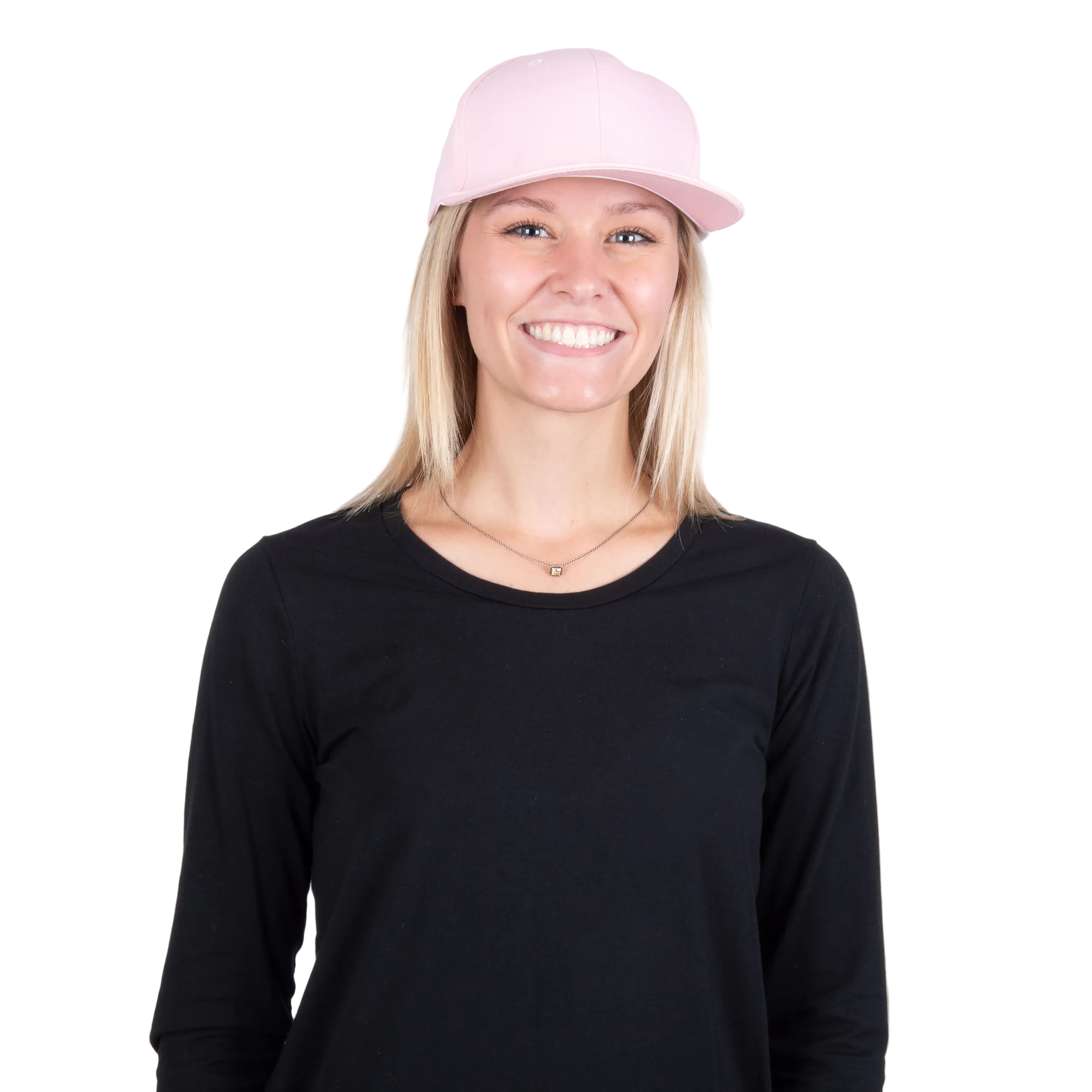 A smiling woman with blonde hair wearing a light pink baseball cap with a cooling insert and a black long-sleeve shirt, photographed against a solid white background.