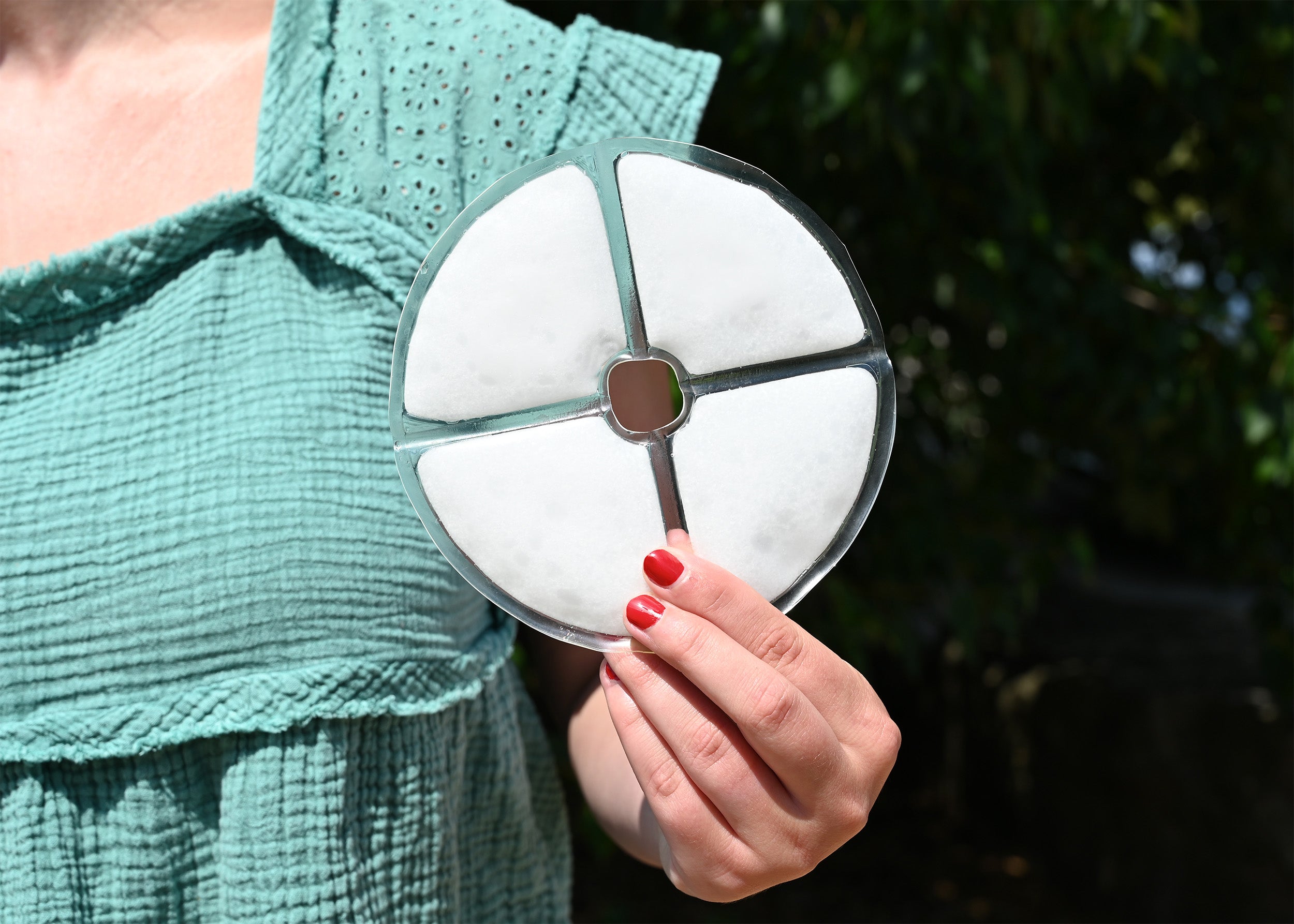 Woman holding a Cool58 Large Bra Phase Change Cooling Pack outside