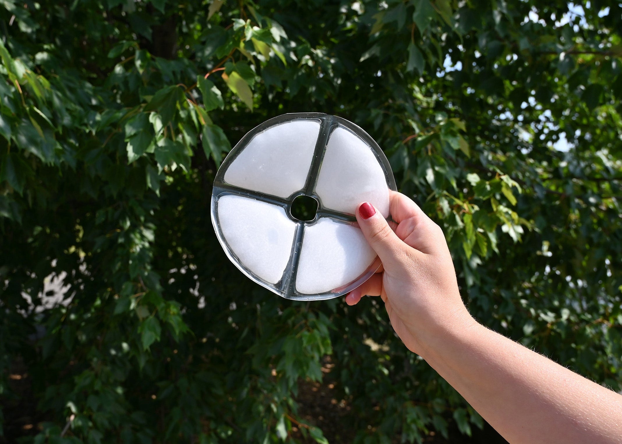 Person holding a Cool58 Phase Change Cooling Hat Insert outside