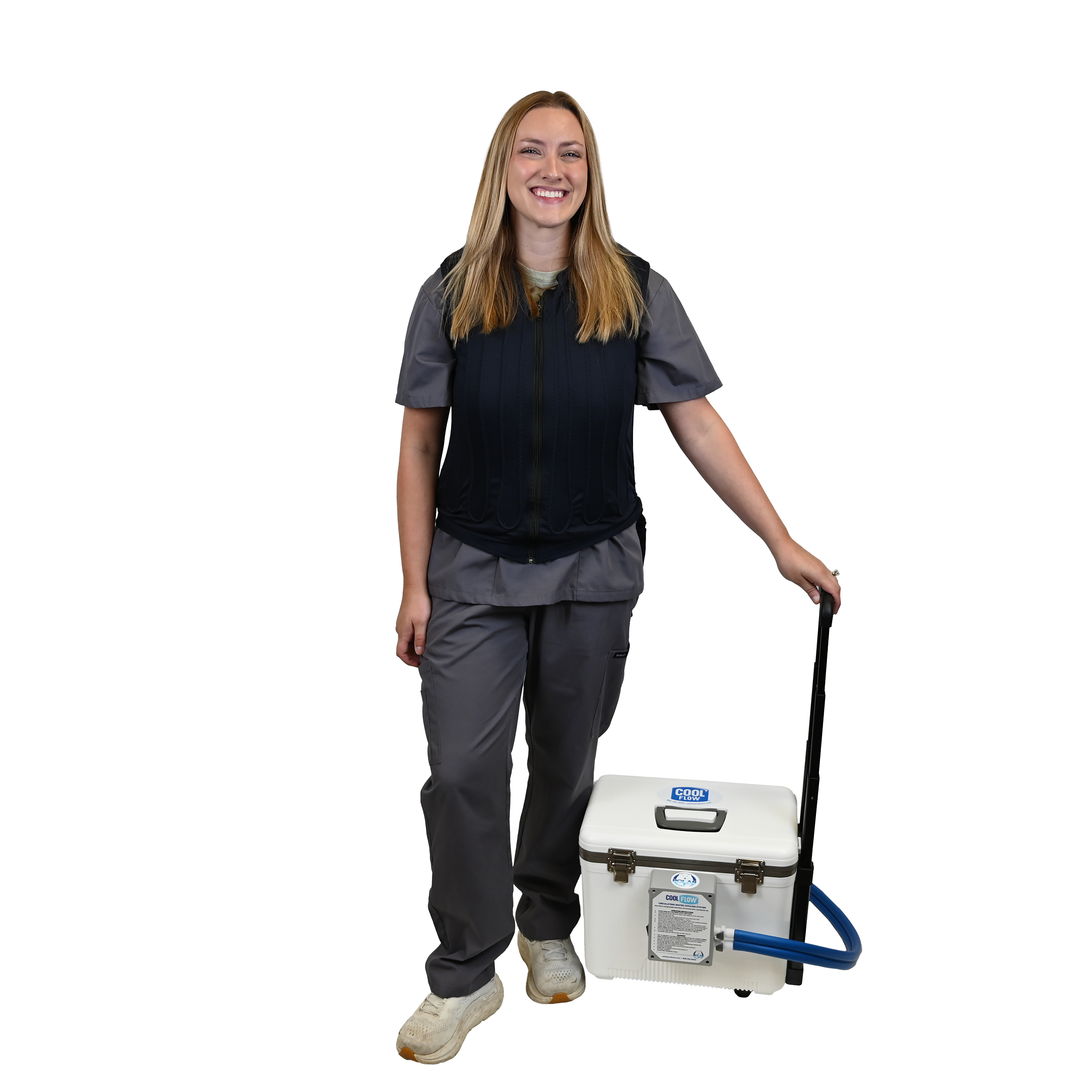 A woman in a dark navy fitted cooling vest and gray scrub top stands next to a white portable cooling reservoir with a blue hose, holding its handle against a solid white background.