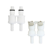 Two white plastic dual-port connector components shown on a plain white background, both upright, with small black O-rings and a metal label reading KCORCH.