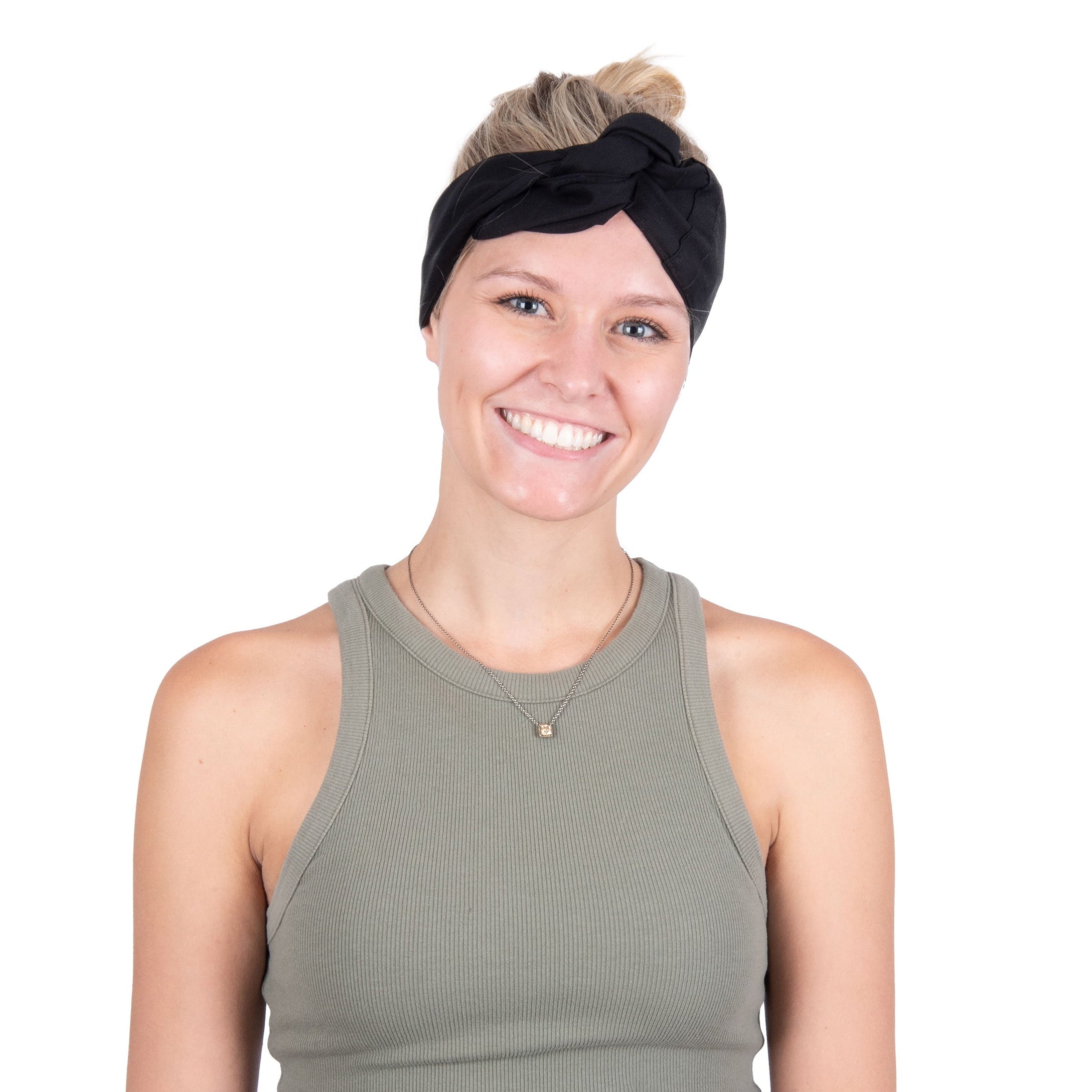 A smiling woman with blonde hair in a bun wearing a black deluxe cooling head wrap and an olive green ribbed tank top, photographed against a solid white background.