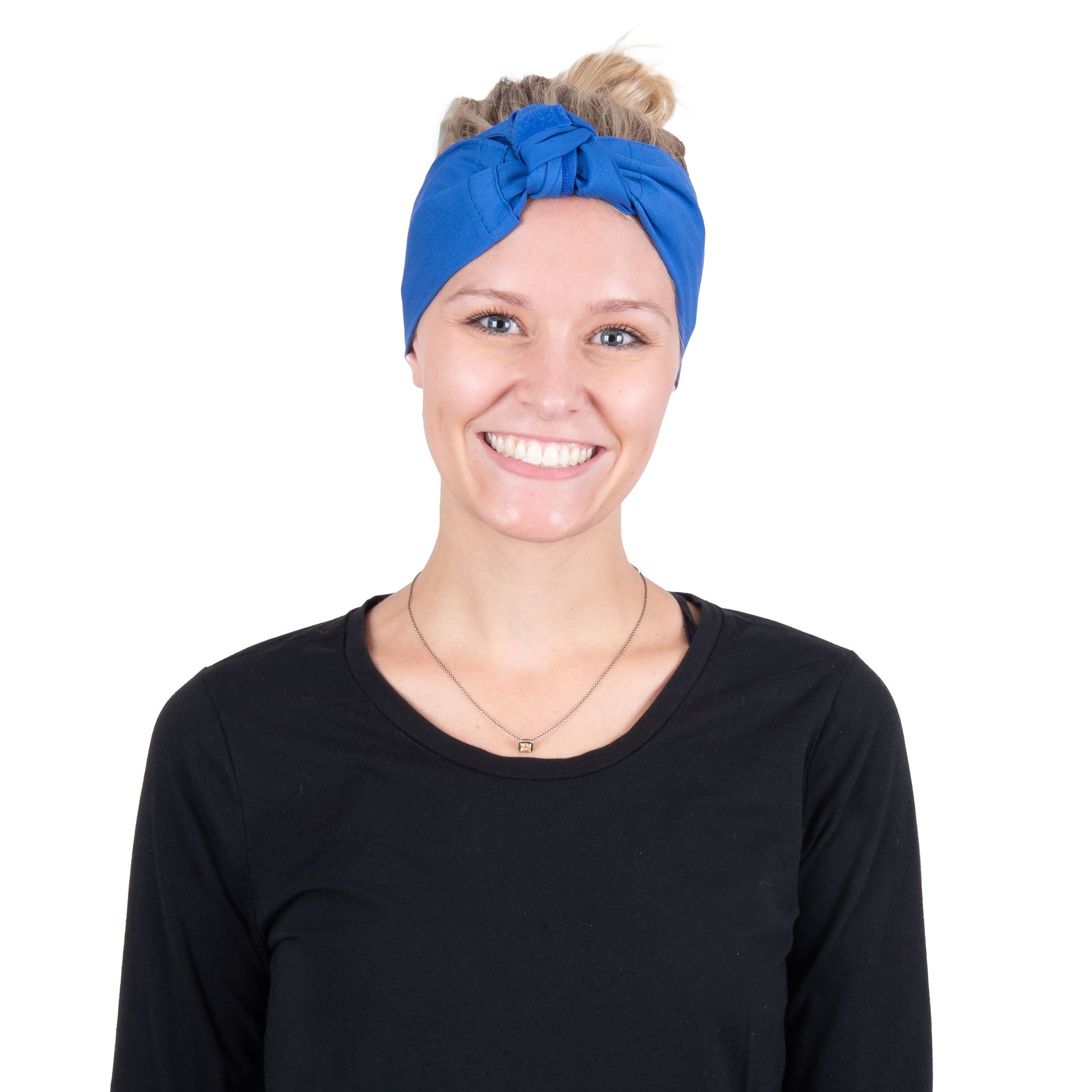 A smiling woman with blonde hair in a bun wearing a bright blue deluxe cooling head wrap and a black long-sleeve top, photographed against a solid white background.