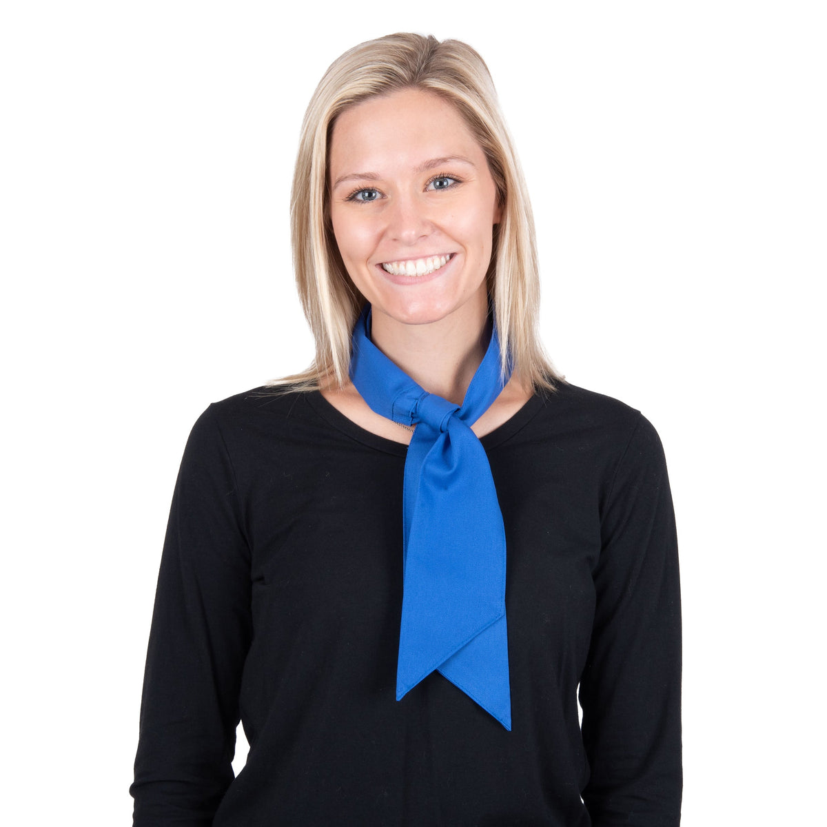 A smiling blonde woman wearing a bright blue deluxe cooling neck wrap tied neatly around her collar over a black long-sleeve top, photographed against a solid white background.