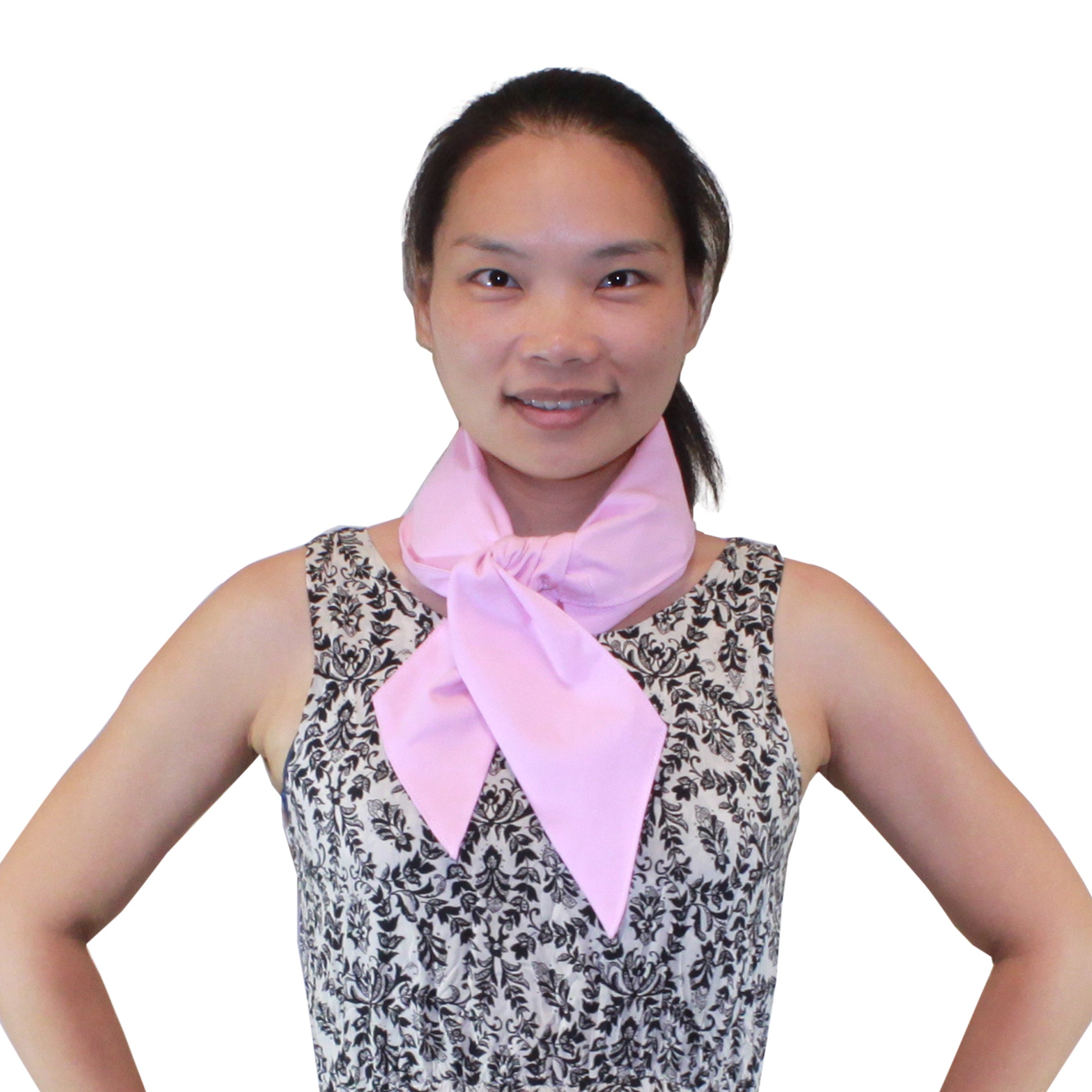 Woman wearing a patterned dress with a pink Deluxe Cooling Neck Wrap on a white background