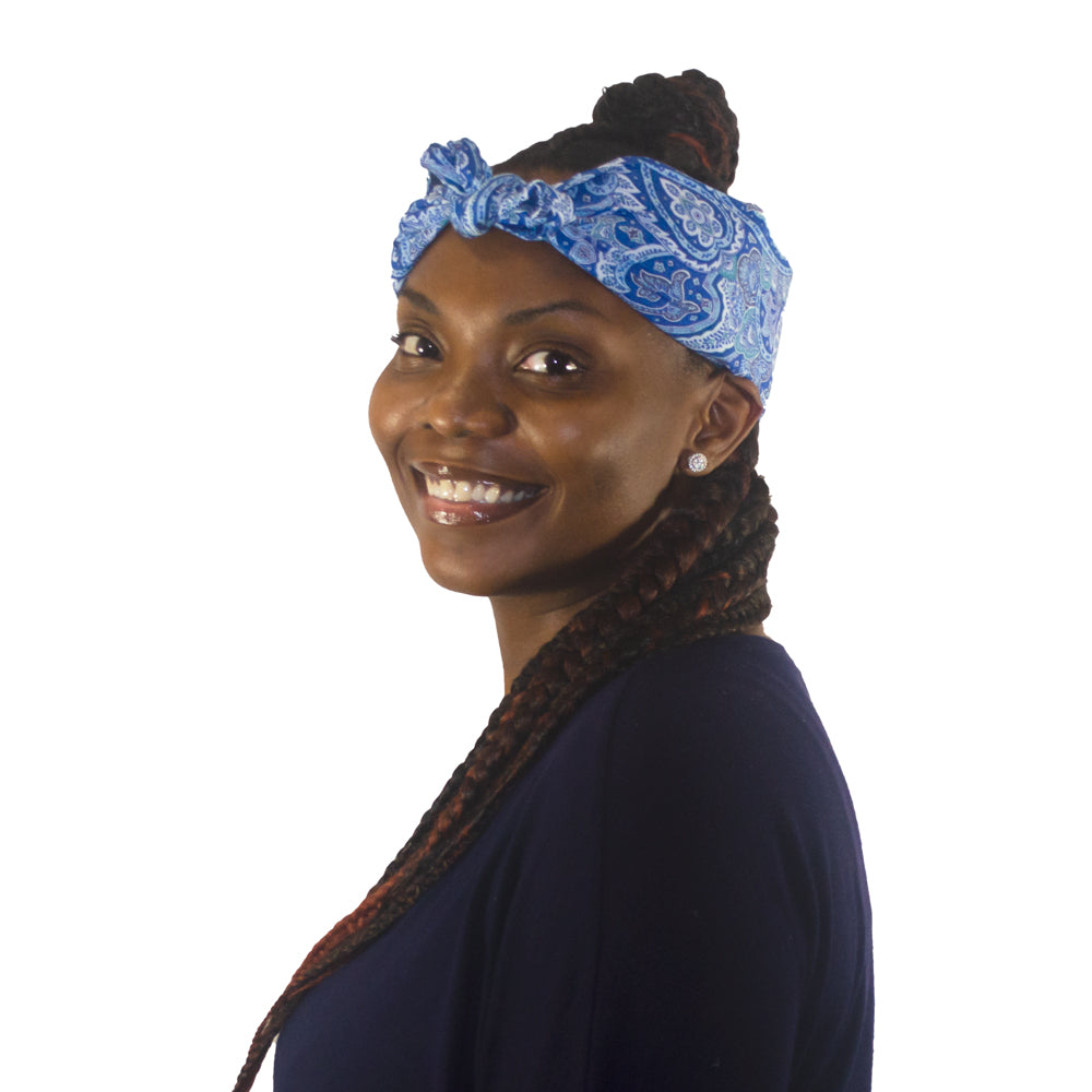 Woman smiling and wearing a blue patterned Cooling Head Wrap on a white background