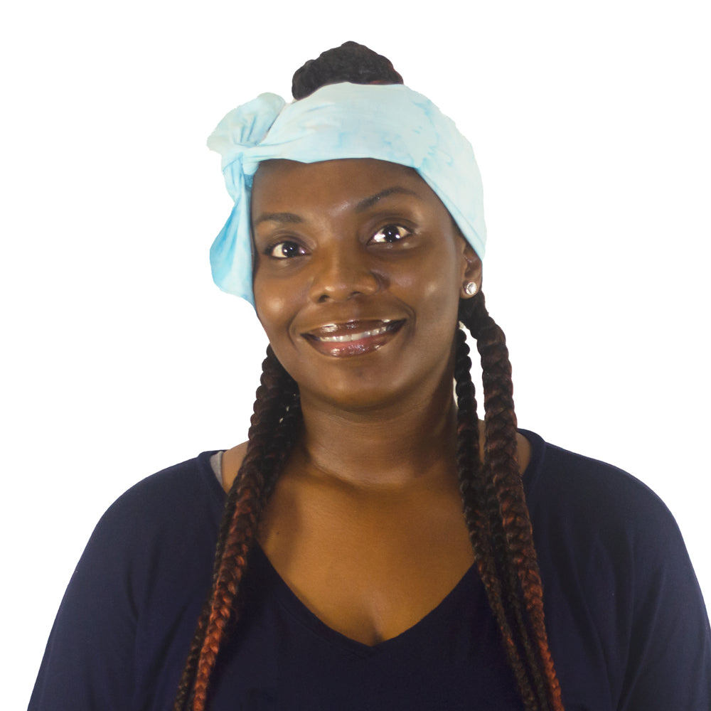 Smiling woman with braided hair wearing a turquoise Cooling head wrap on a white background