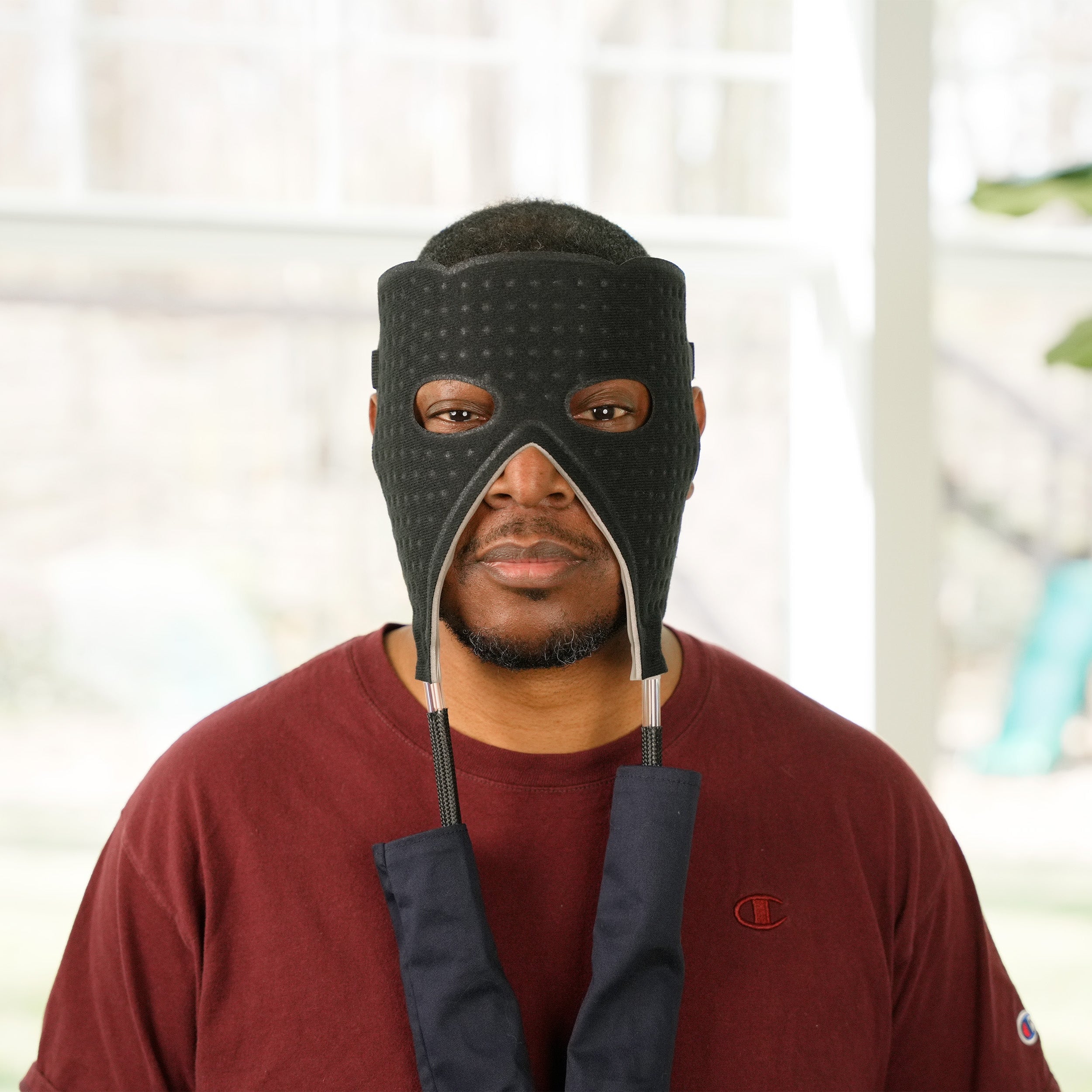 Man wearing a Face cold therapy pad in an indoor setting