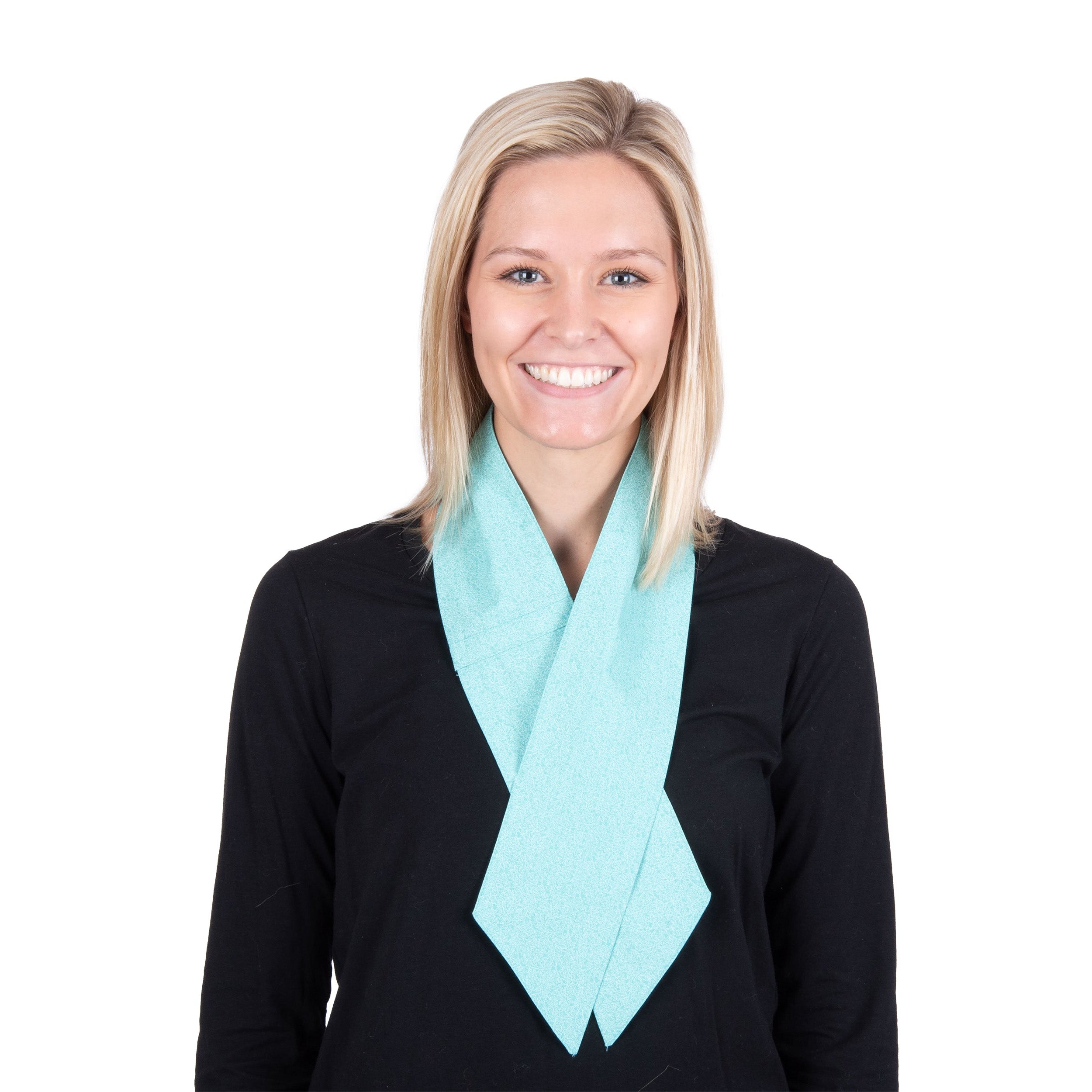 A smiling blonde woman wearing a turquoise cooling fashion neck scarf around her neck over a black long-sleeve top, shot against a plain white background.