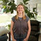 Woman standing in a living room wearing a Gray Cooling Fashion Vest with Kool Max® packs