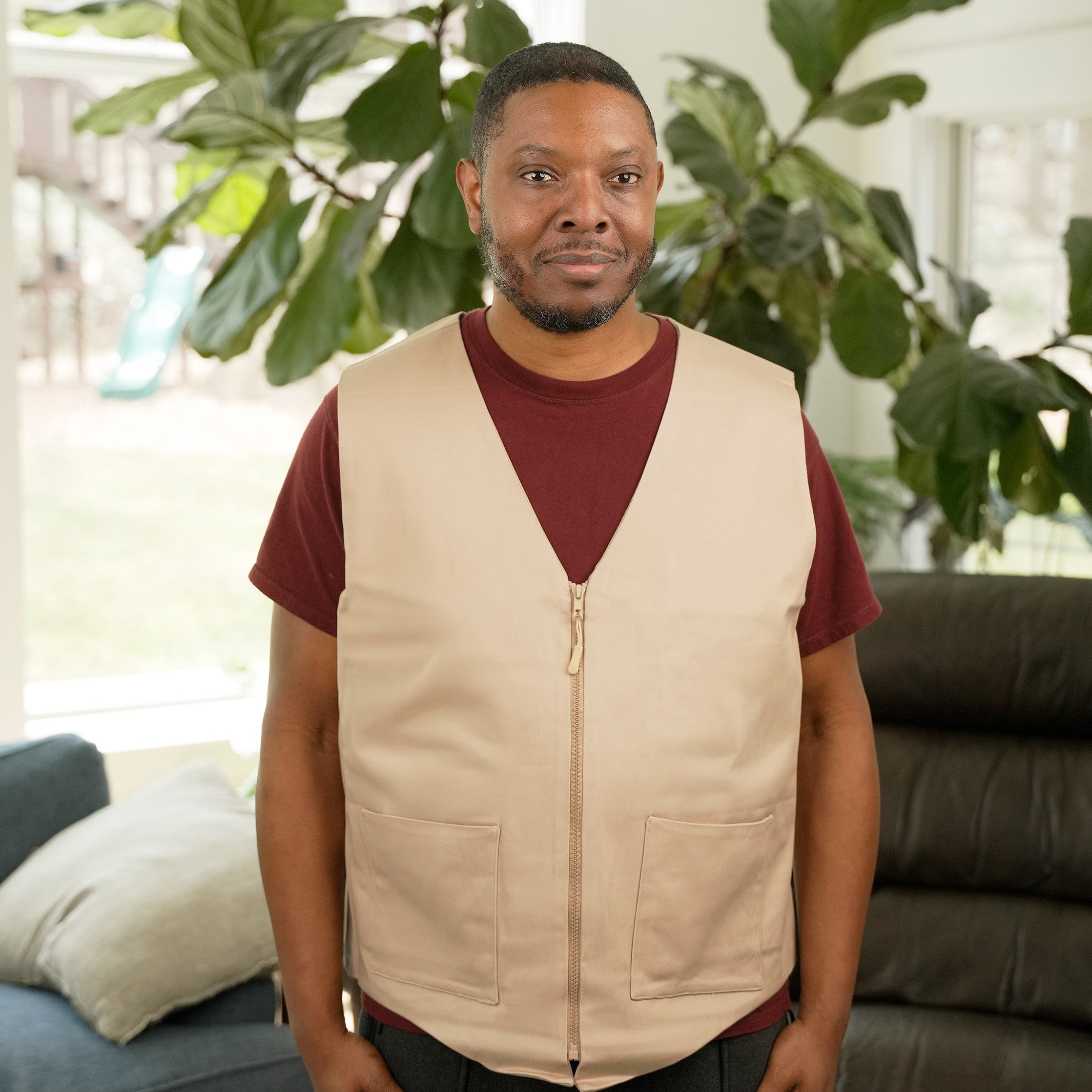 Man wearing a Khaki Kool Max® Fashion Vest in a bright living room.