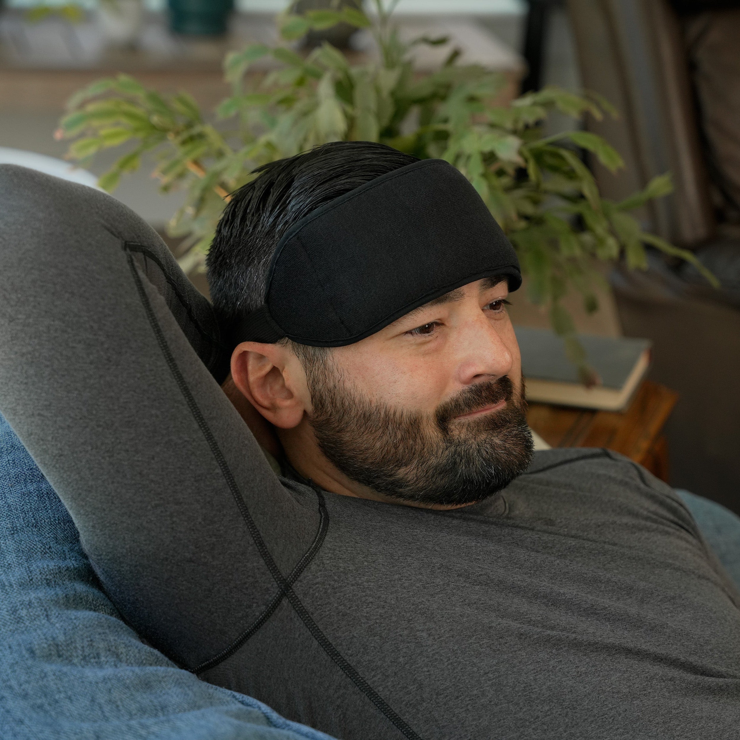 Man wearing a Soft Ice® Head Wrap in a living room setting