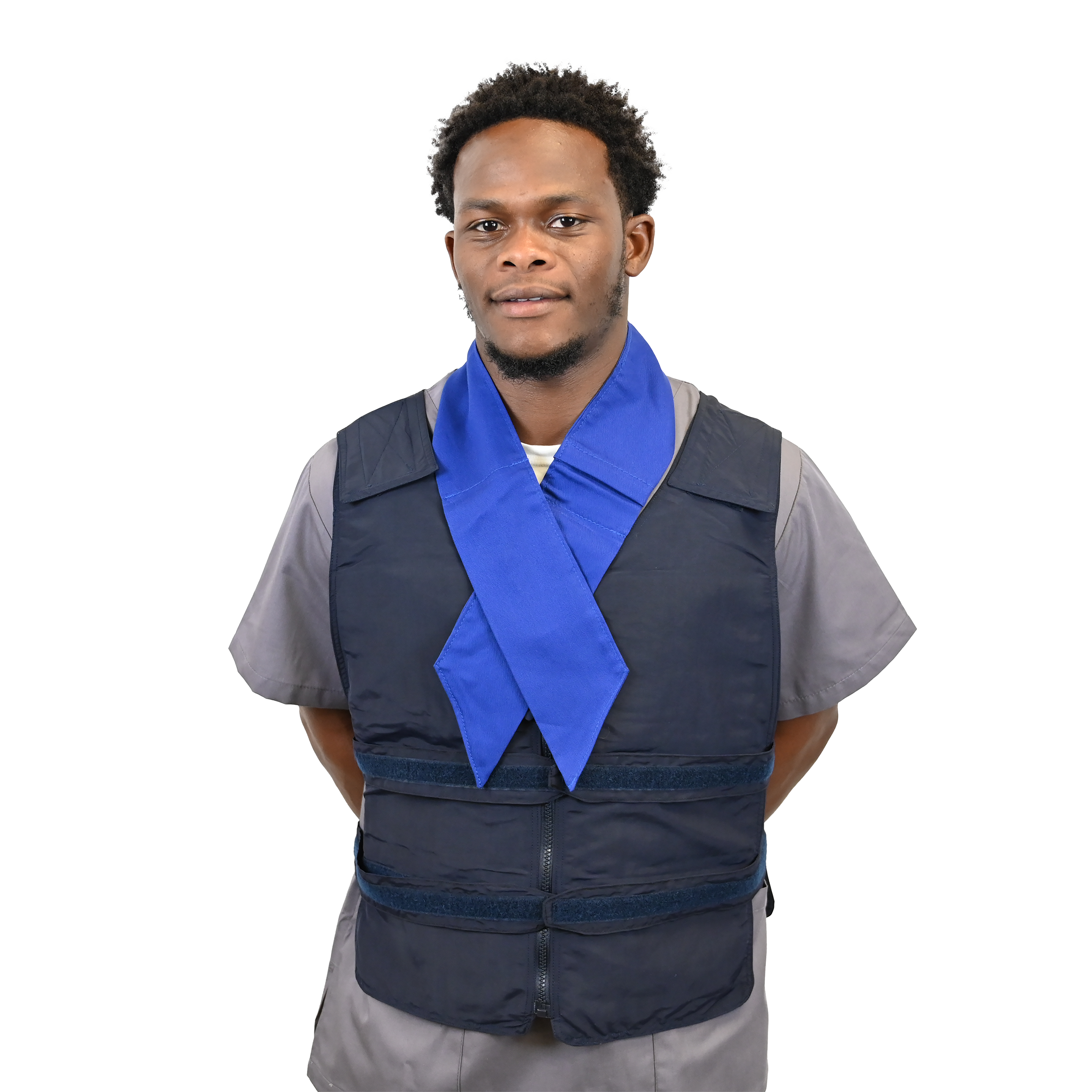 A man wearing a dark navy blue nylon adjustable cooling vest over a gray shirt, with a bright royal blue cooling neck scarf or collar draped around his neck, set against a solid white background.