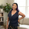 A woman with purple hair is wearing a navy blue waist Adjustable Zipper Cooling Vest in nylon in a brightly lit living room setting.