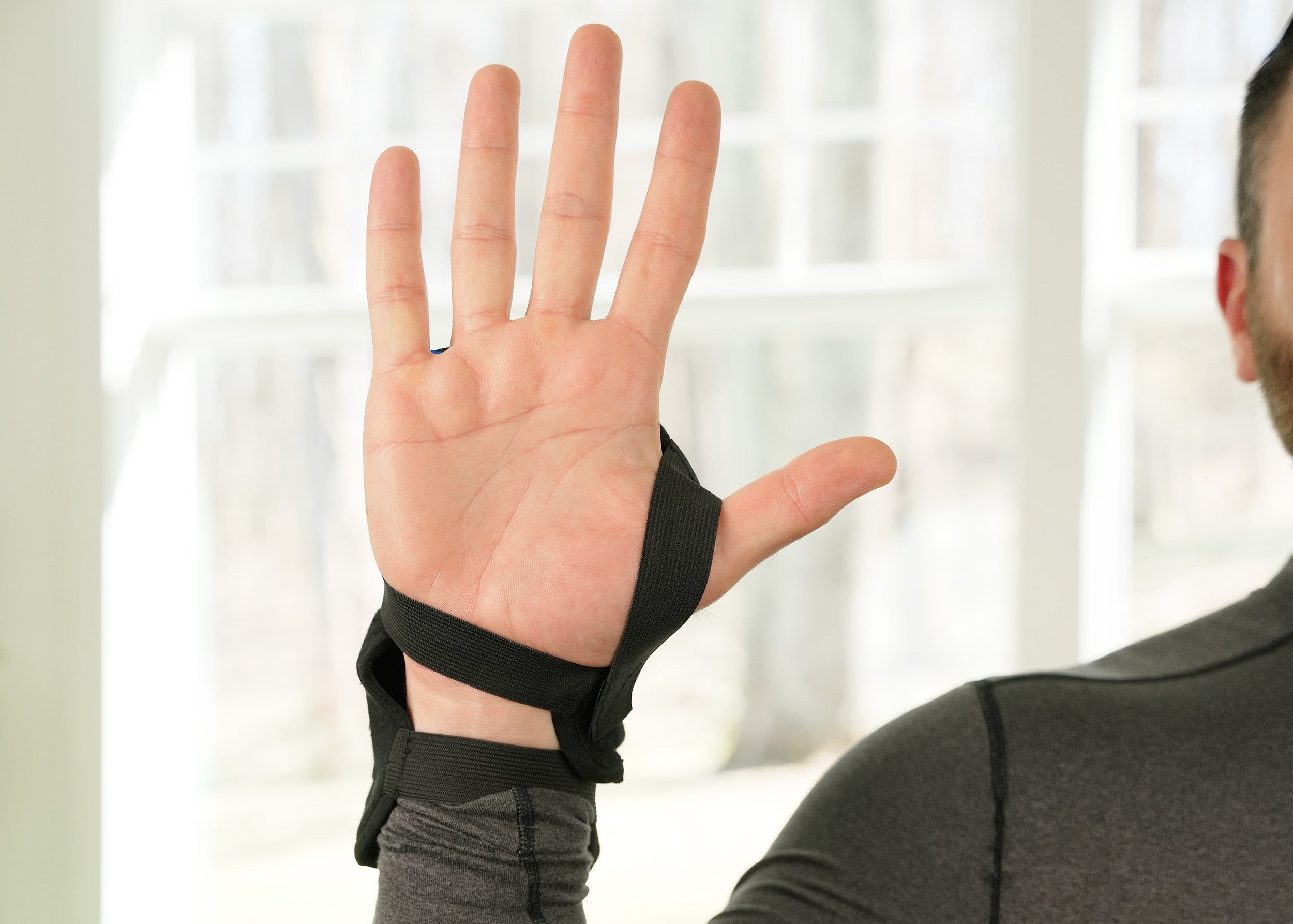 Person wearing a Soft Ice® Wrist Wrap with a blurred indoor background