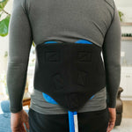 Man wearing a Active Ice® 3.0 Back or Hip Compression Wrap on his lower back in a home setting.