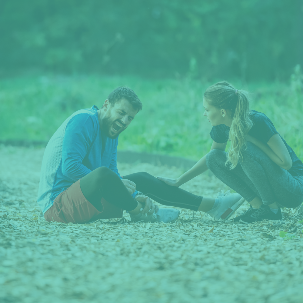 Two people sitting on a gravel path with a teal overlay