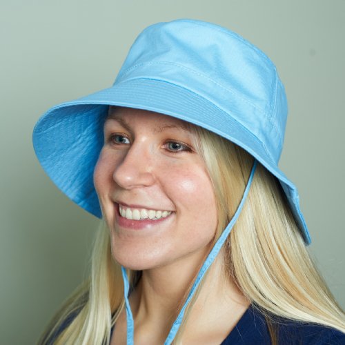 Woman wearing a blue cooling bucket hat against a plain background