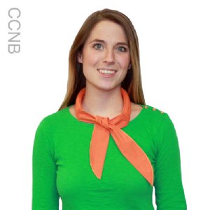 Woman wearing a green sweater with an orange cooling neck band on a white background