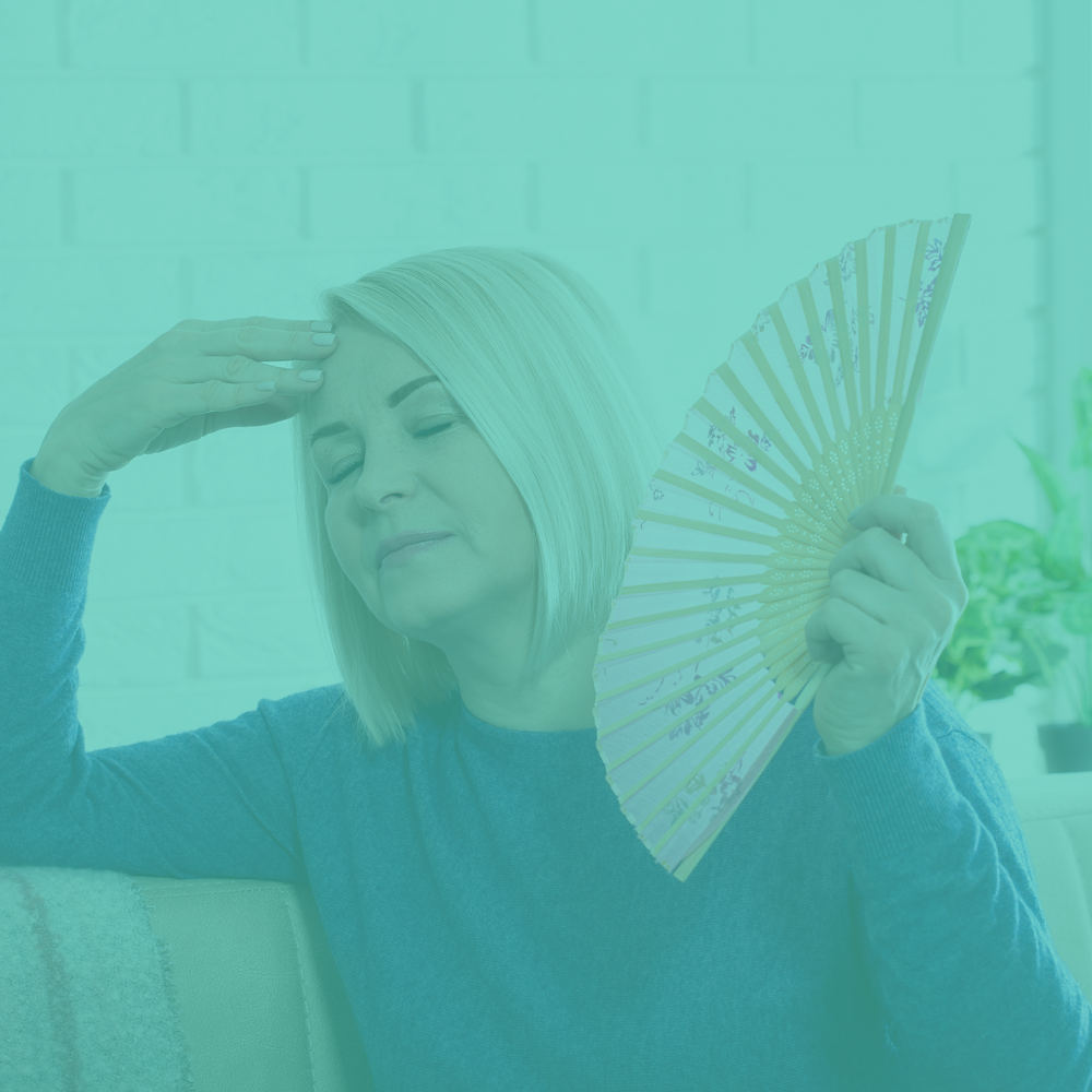 Woman holding a fan with a teal overlay