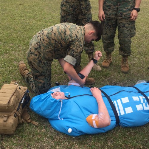 Military training exercise with with the Polar Life Pod® on a grassy field.