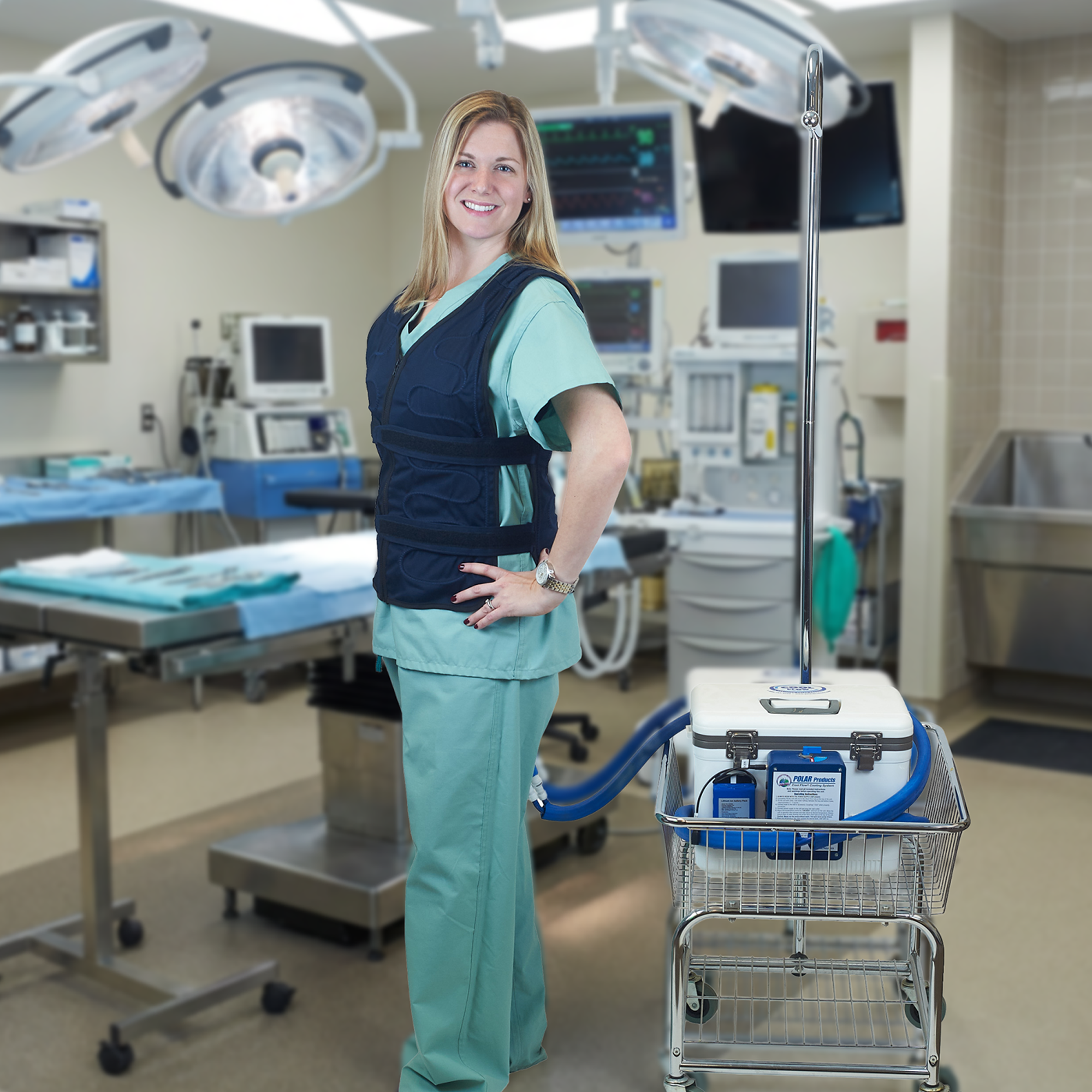 Person in surgical attire wearing an adjustable circulating cooling vest with a 13-quart cool flow or® cooling system in a cart standing in an operating room.