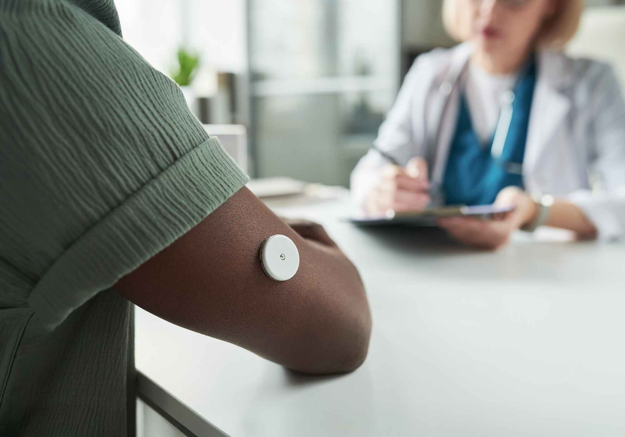 Person with a bandage on their arm in an office setting