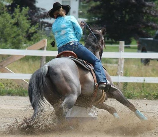 Woman riding a horse wearing a Kool Max adjustable zipper front cooling vest